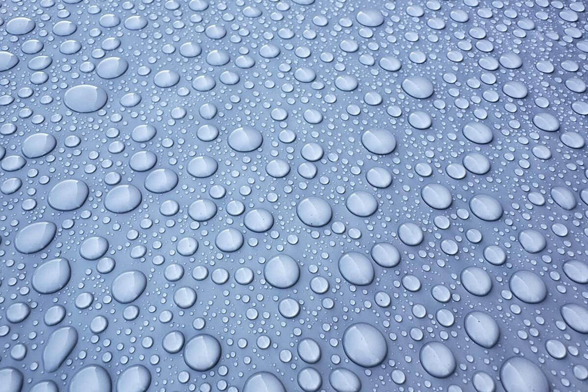 Closeup of liquid roofing repelling the water lees court anchor